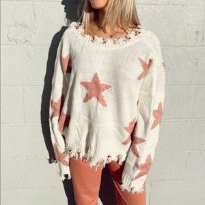Oversized Star sweater with distressed detailing around the v-neck neck